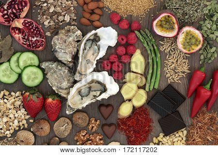 Aphrodisiac food selection for good sexual health on oak wood background.