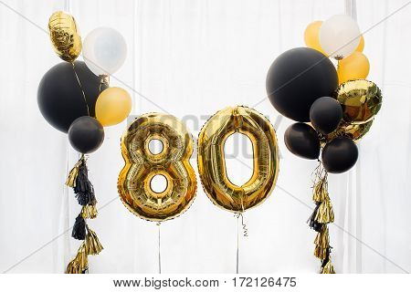 Decoration for birthday, anniversary, celebration of the eight hundred anniversary, white background, gold and black balloons with tassels