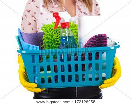 Close up picture of female housekeeper holding a basket of cleaning supplies