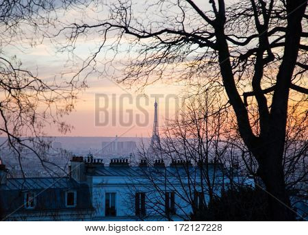 Eiffel Tower seen from Montmartre hill sunset in Paris France.