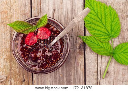 Raspberry Jam In A Jar And Fresh Berries On The Wooden Table