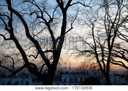 Eiffel Tower seen from Montmartre hill, sunset in Paris, France.