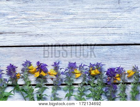 wildflowers on a wooden surface.the unpretentious rustic background