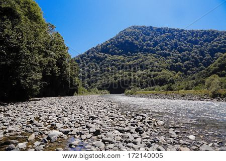 cold mountain river rapid stream flows between the mountains
