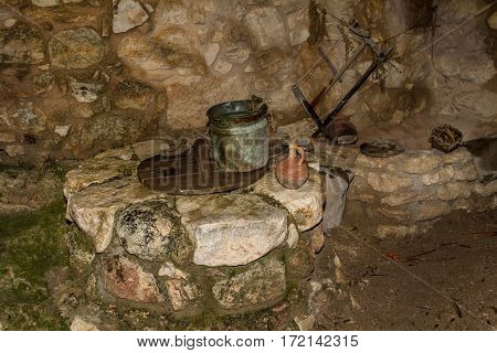 The Old iron bucket and the clay jug on the ancient stone water well in Nazareth Village Israel. Ancient Holy Land