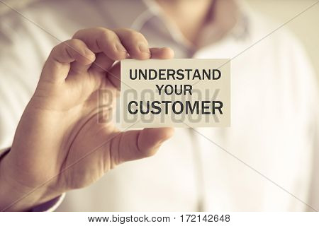 Businessman Holding Understand Your Customer Card