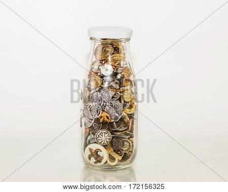 a bottle of shiny apparel fasteners - buttons