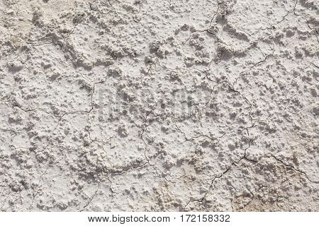 White arid cracked lumpy dry textured desert soil