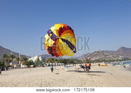 KHORFAKKAN UAE - DEC 1 2016: Parasailing on the beach in Khor Fakkan Emirate of Sharjah United Arab Emirates