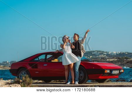 Young Couple Near The Red Ferrari