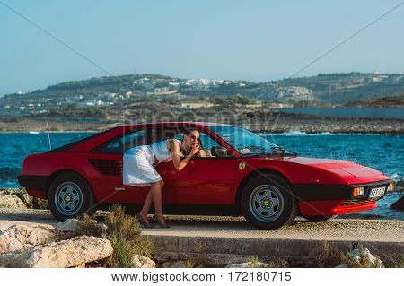 Young Girl Do Makeup In The Rear View Mirror Of Ferrari