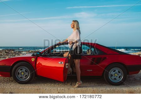 Young Beautiful Girl Posing Near The Red Ferrari