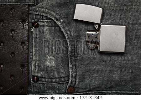 Men`s modern fashion. Jeans and a lighter. Flat top view.