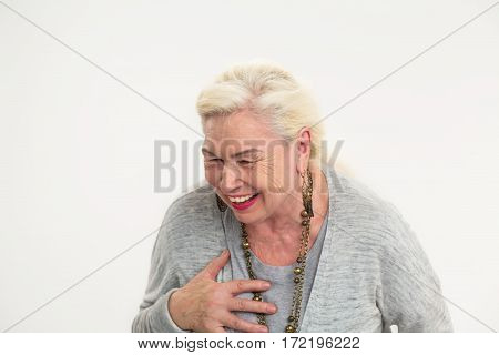 Isolated elderly woman laughing. Cheerful senior female.