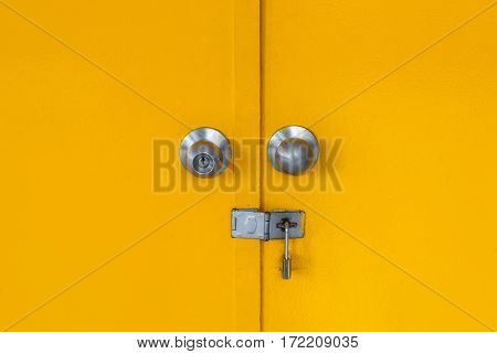 Closeup to Locked Yellow Metal Door .