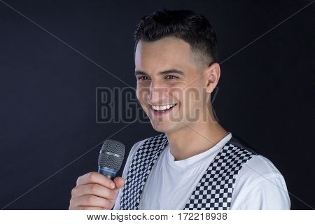 Male Black-haired Singer Performs Singing To Microphone