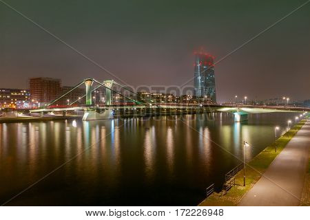Picturesque views of the city's waterfront and skyscrapers at night in Frankfurt. Germany.