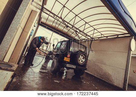 Leningrad region, Russia - February 18, 2017 Jeep Wrangler tj at the car wash, Wrangler is a compact SUV produced by Chrysler
