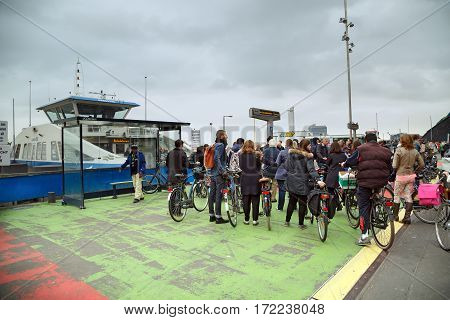 AMSTERDAM/ NETHERLANDS - OKTOBER 23. People stand in the queue for the free ferry across the river IJ on Oktober 23, 2016 in Amsterdam, The Netherlands.