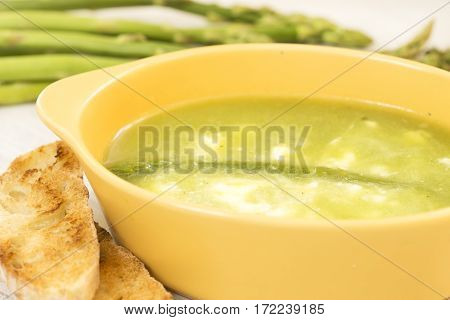 Asparagus soup in a yellow ceramic dish