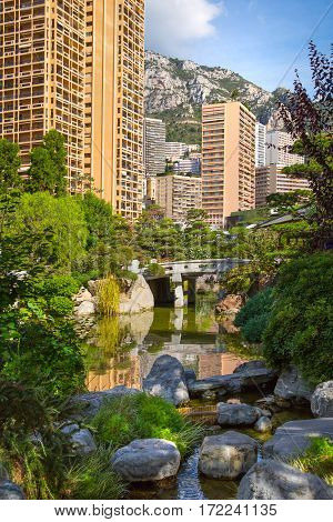 Monaco, Monte Carlo - September 17, 2016:  Jardin Japonais, Japanese Garden view with residential buildings at the background.