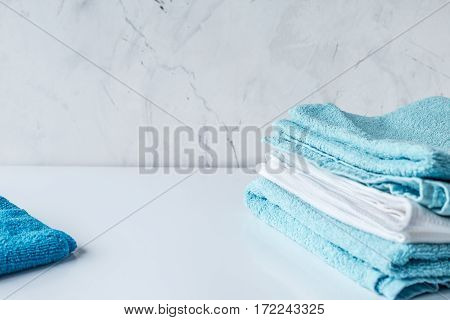 Blue towels set in laudry on gray table backgruond mock up