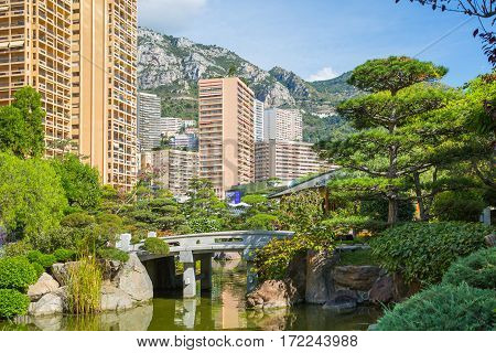 Monaco, Monte Carlo - September 17, 2016:  Jardin Japonais, Japanese Garden view with residential buildings at the background.