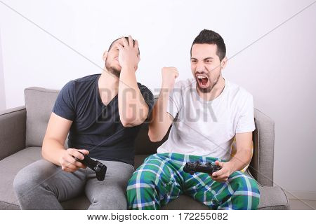 Friends Playing Videogames On Couch.