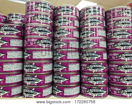 New York Februrary 14 2017: Cans of Albacore tuna are stacked on a shelf in a Trader Joe's store.