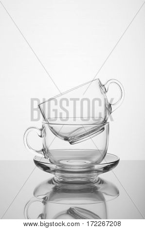 Two transparent glass cups on the white background