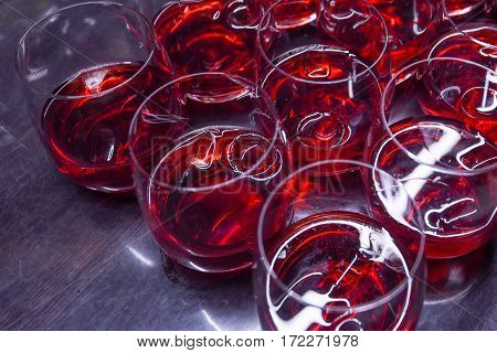 Many alcoholic cocktail drinks with crainberry or strawberry on pub bar