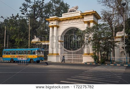 KOLKATA, INDIA -FEBRUARY 12, 2017: A public transport bus crosses the entrance of the Gothic architectural Governor house near Dharmatala Chowringhee area in Kolkata.
