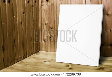 Blank White Poster Leaning At Wooden Wall In Plank Wood Room,mock Up For Adding Your Content.