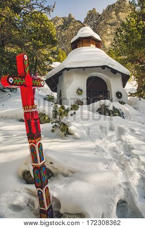 Chapel and red cross at symbolic cemetery in High tatras mountains Slovakia