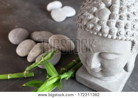 buddha head with stones , bamboo and tabular