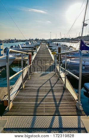 ROCCELLA IONICA, ITALY - September 30, 2016: Port of Roccella Ionica in the evening with fishing boats and luxury yachts. Port of Ionian Sea, Calabria, south Italy.