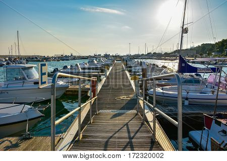 ROCCELLA IONICA, ITALY - September 30, 2016: Port of Roccella Ionica in the evening with fishing boats and luxury yachts. Port of Ionian Sea, Calabria, south Italy.