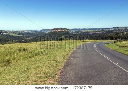 Rural Asphalt Road Curving Through Rural Landscape