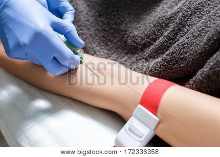 nurse taking blood sample from patient's arm. Preparation of blood to the procedure Plasmolifting.