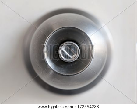 A door knob with a white door.