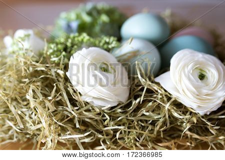 Still life with easter eggs and flowers for a greeting card
