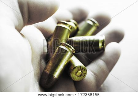 Bullets In Hand Close Up With Black and White Background High Quality