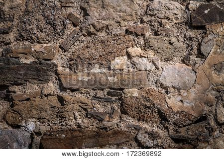 Part of an old stone wall with clay masonry