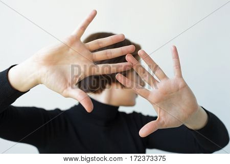 Girl Turns Aside, Stretching Her Hands Forward. Pushing Someone Away From Contact