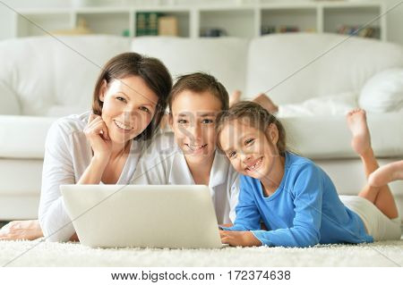 mother with son and daughter using laptop