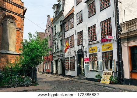 RIGA/ LATVIA - JULY 25, 2015. Evangelical Lutheran St. Johns Church and ancient medieval residential buildings on the Jana street. Old Riga, Latvia