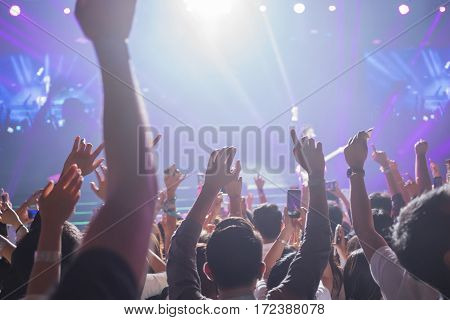 Crowd enjoying concert happy people jumping large group celebrating new year holiday party background fun concept