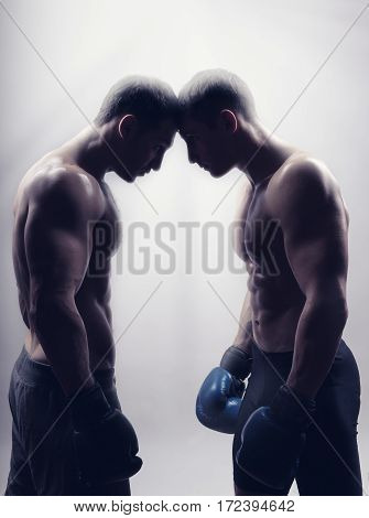 Two boxer with boxing gloves before a fight on a light background. Boxing concept