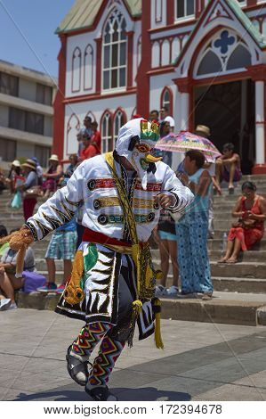 ARICA, CHILE - FEBRUARY 10, 2017: Members of a Waca Waca dance group in ornate costume performing at the annual Carnaval Andino con la Fuerza del Sol in Arica, Chile.