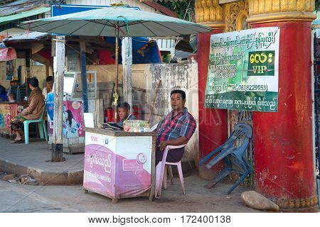 MYAWADI, MYANMAR - DECEMBER 16, 2016: Street changed money on the city street